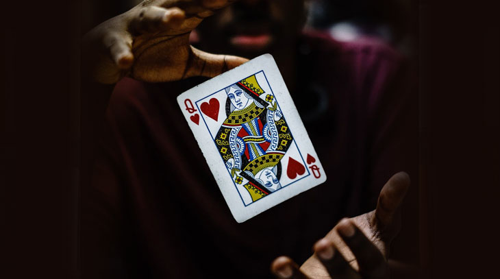 Hands and playing card